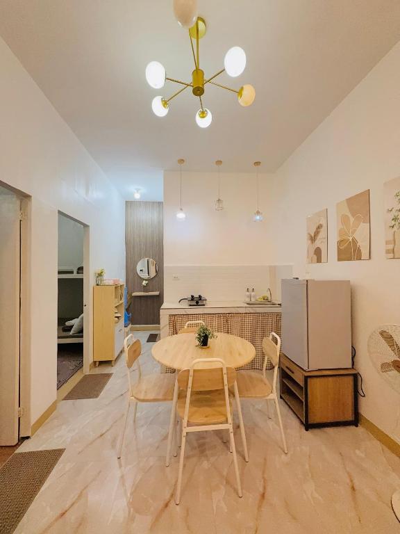 a kitchen and dining room with a table and chairs at DM Guesthouse - Impasugong Bukidnon in Impasugong