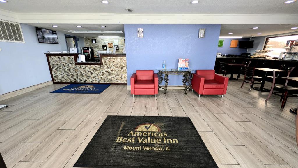 a restaurant with red chairs and a table in a room at Americas Best Value Inn Mount Vernon in Mount Vernon