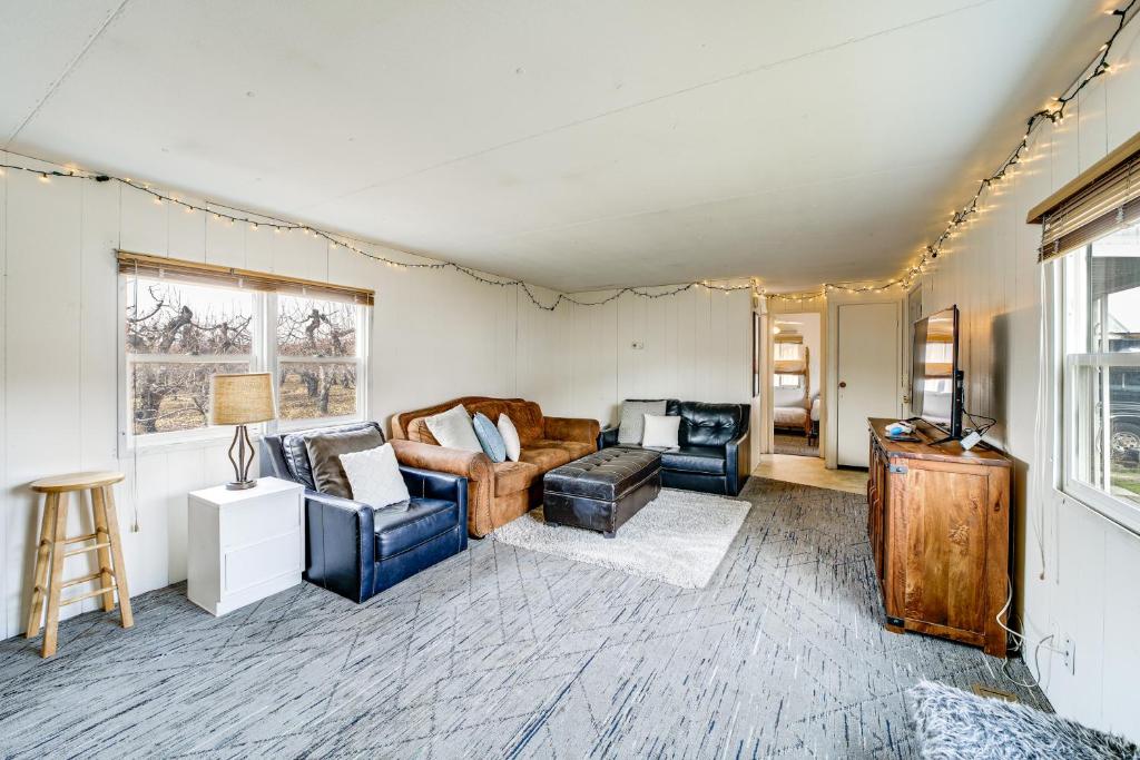 a living room with couches and chairs and a television at Walk to Loop Trail! East Wenatchee Basecamp in East Wenatchee