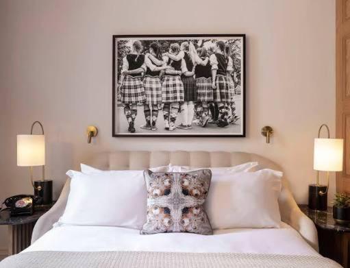 a bedroom with a bed with a picture on the wall at Gust hotel in Marrakesh
