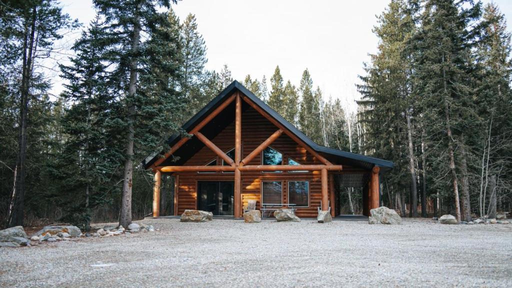 a log cabin in the middle of a forest at Grizzly Den in Valemount