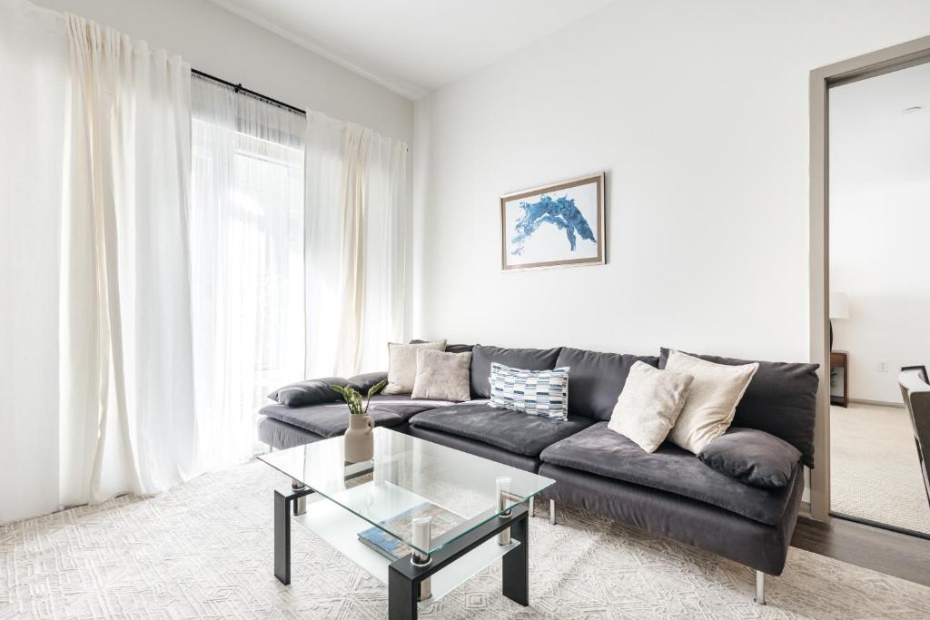 a living room with a couch and a glass table at Brilliant 2BD condo in Los Angeles
