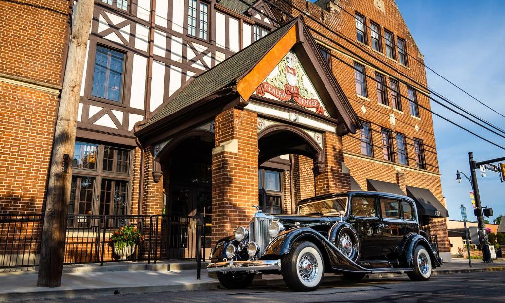 an old car parked in front of a building at General Denver Hotel in Wilmington
