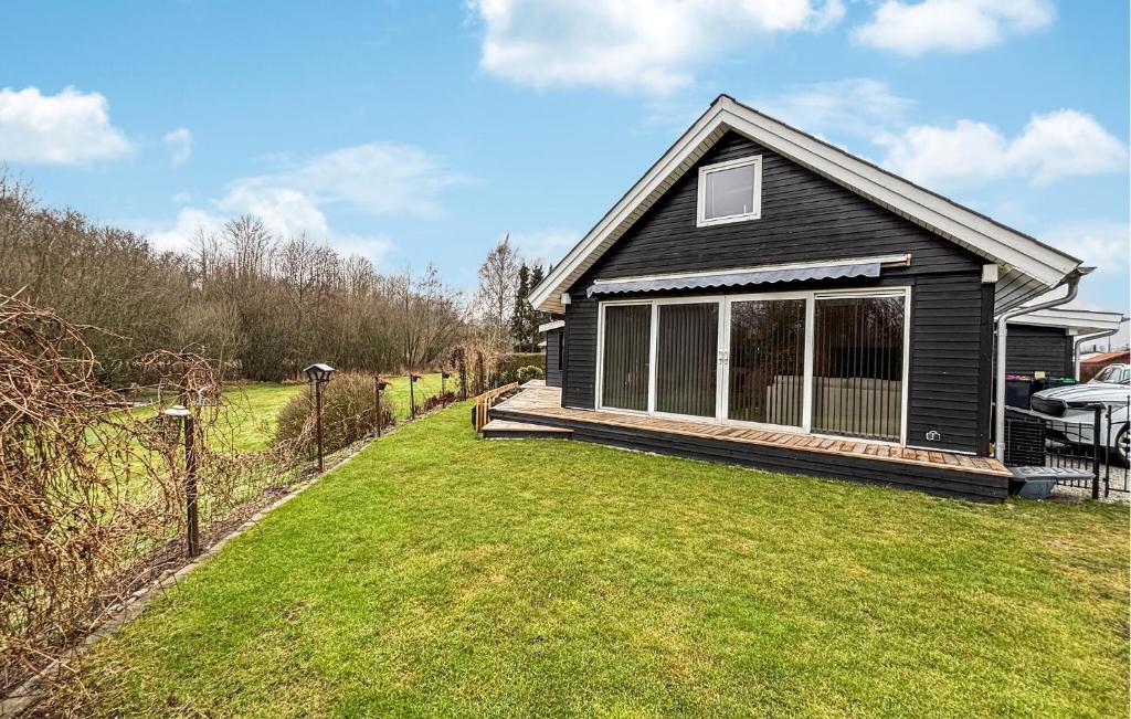 a black house with a large yard in front of it at 3 Bedroom Cozy Home In Haderslev in Haderslev