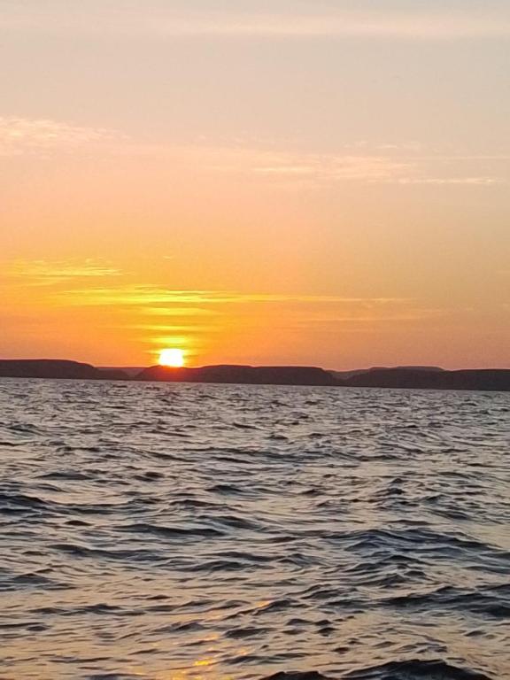 a sunset over a body of water at Sunrise in Abu Simbel