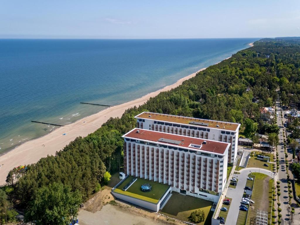 an aerial view of a hotel and the beach at Large apartment with sea view, indoor pool in Pobierowo
