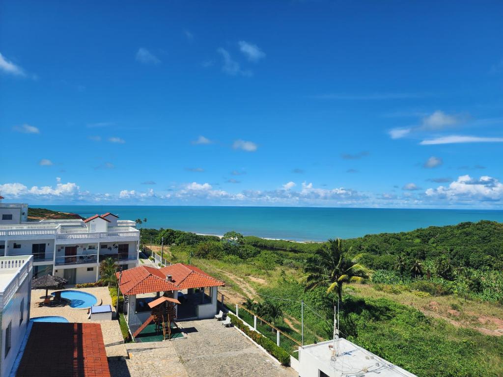 a view of the ocean from the balcony of a house at Apt Vista para o Mar in Conde