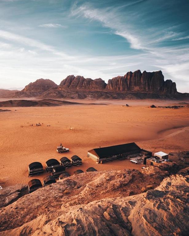 a group of cars parked in the desert at Wadi Rum Trip Bedouin Camp in Wadi Rum