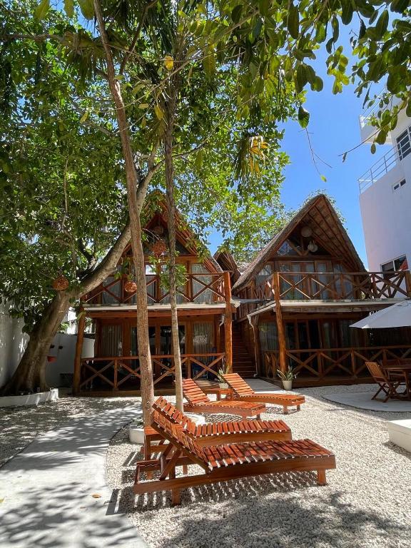 a group of benches in front of a building at Nido BY puerto morelos in Puerto Morelos
