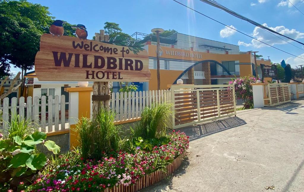 a welcome to wild bird hotel sign in front of a building at Wildbird Hotel in Tràm Chim