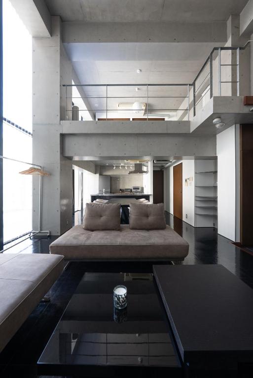 a living room with a large couch and a table at ARTK'SJosui in Fukuoka