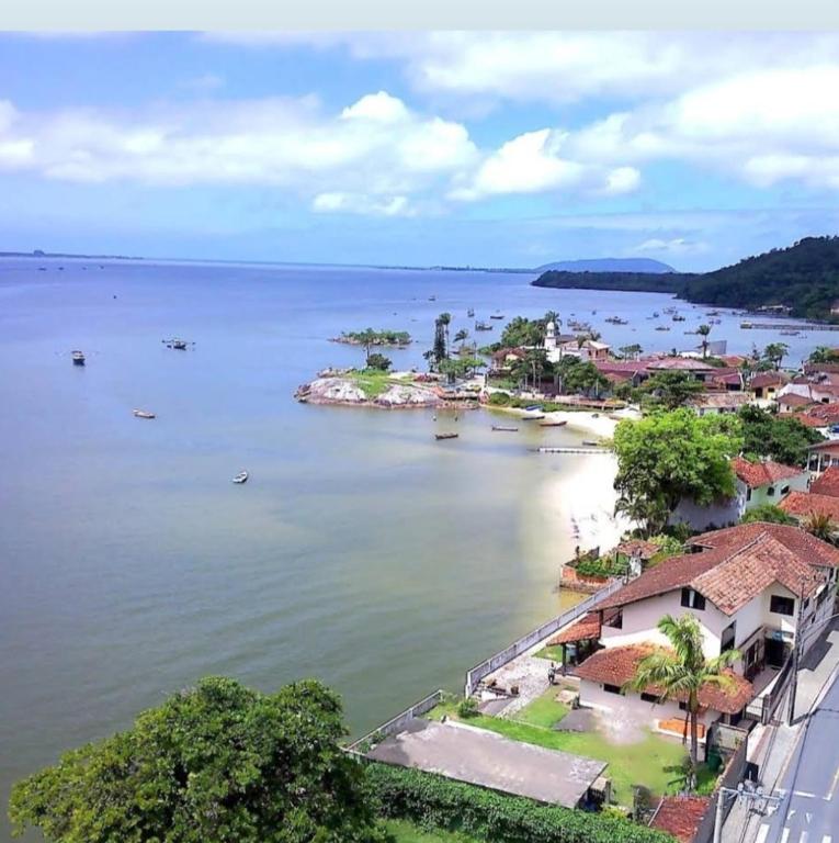 an island in the middle of a large body of water at Pousada Praia do Calixto in São Francisco do Sul