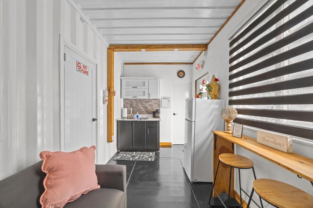 a living room with a couch and a refrigerator at Beachside 1BR Apartment Sleeps 4 in Vega Baja