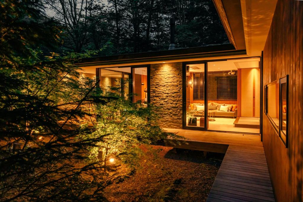 a house with a view of a living room at La Maison Karuizawa in Karuizawa
