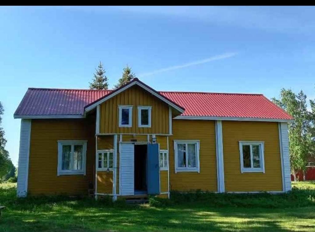 a yellow house with a red roof at Keltainen talo in Ylivieska