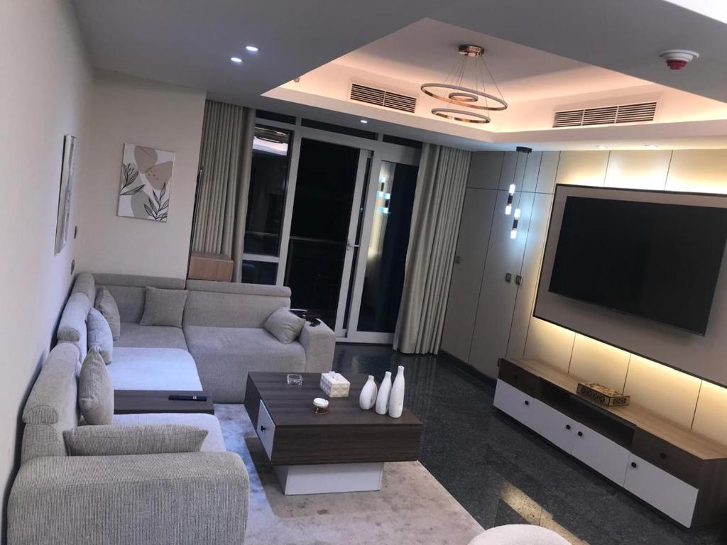 a living room with a couch and a flat screen tv at Crown Mountain in 6th Of October