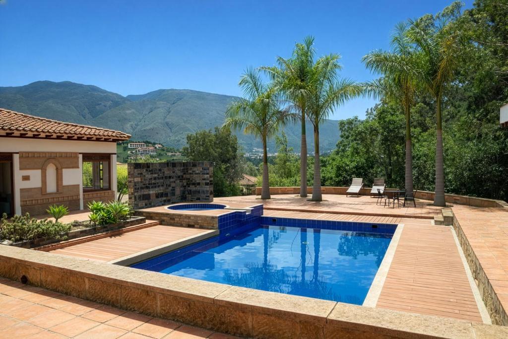 a swimming pool in a backyard with palm trees at Hacienda Cascanueces in Villa de Leyva
