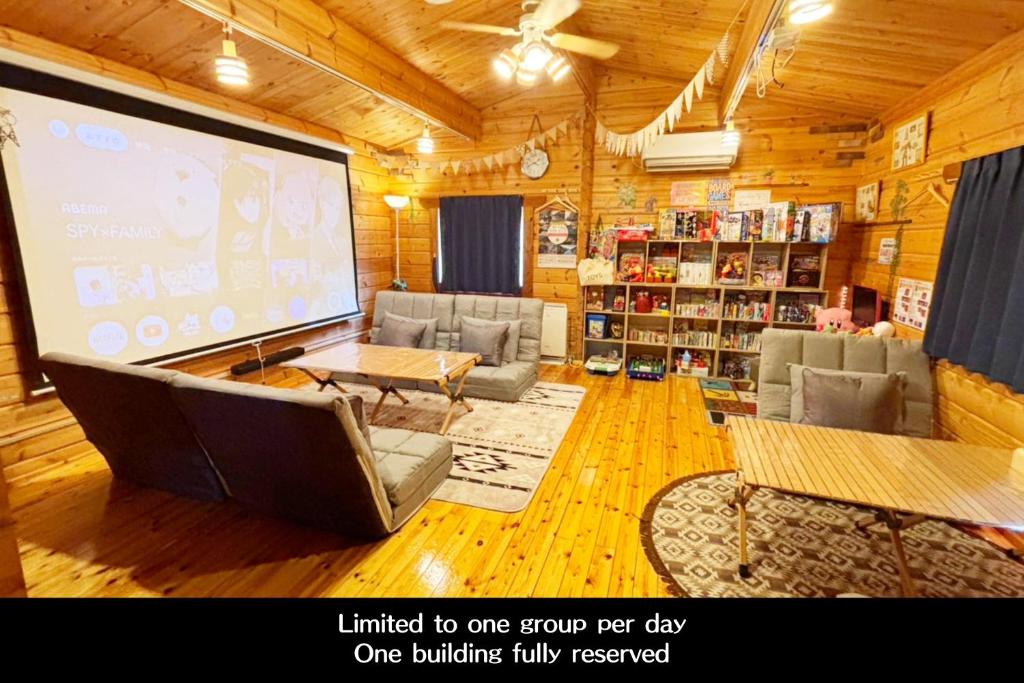 a large screen in a room with a large room with a presentation at Riverside Oasis WAKUWAKU-BASE in Yabuhara
