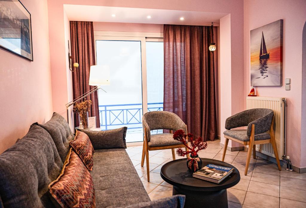 a living room with a couch and a table at Olive Nest, Cozy Apartment in Ammoudara in Ayía Marína