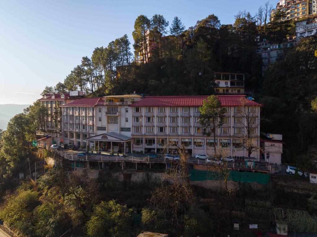 a building on the side of a mountain at 8fold by Larisa, Shimla in Shimla