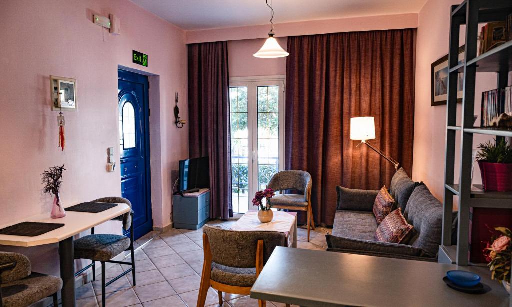 a living room with a couch and a table at Blue Petal Apartment, Relaxed Heraklion Stay in Amoudara Herakliou