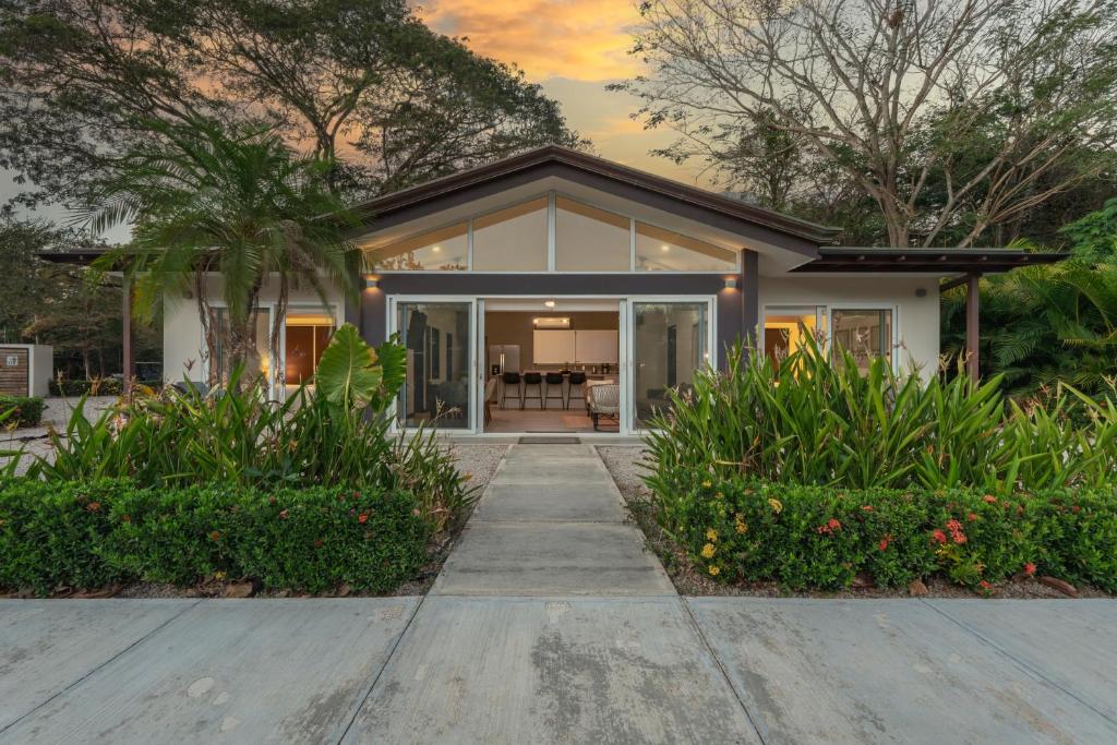 a home with a pathway leading to the front door at The Point 23 At Playa Avellanas in Playa Avellana
