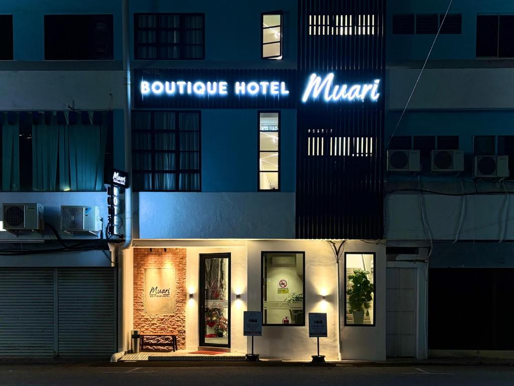 a building with a sign for a boutique hotel at Muari Boutique Hotel in Muar