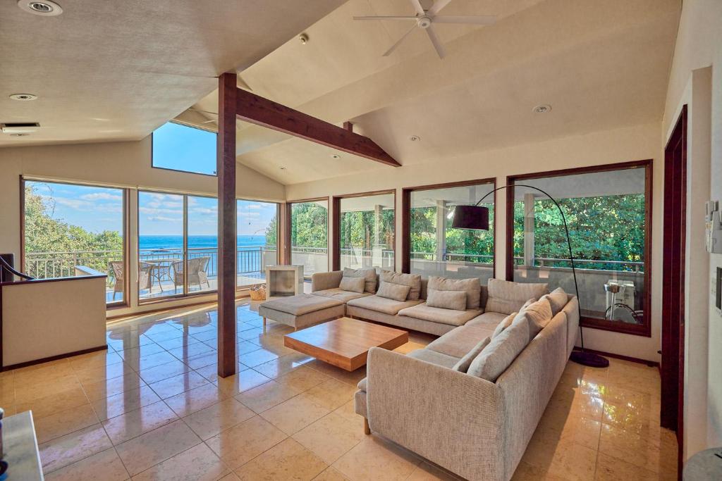 a living room with a couch and a table at UMIBE IseShima in Shima