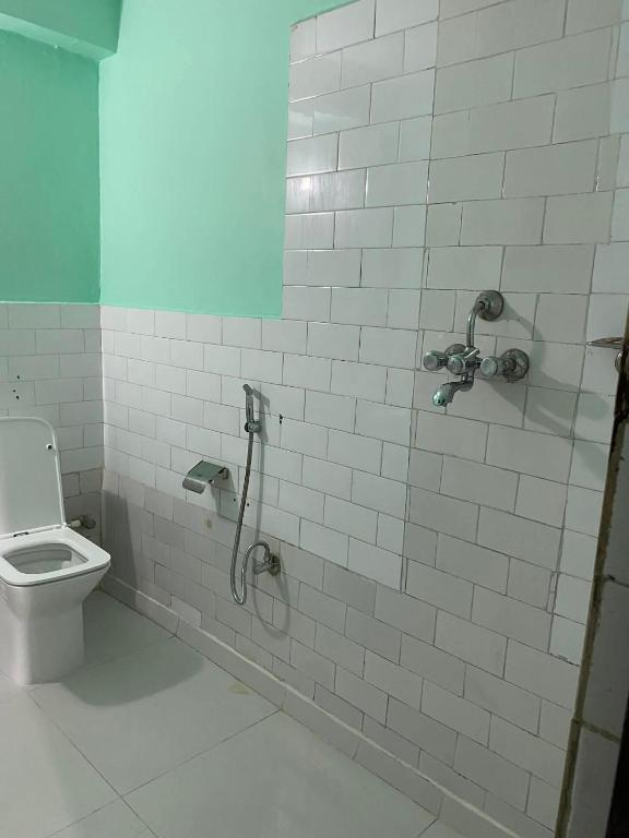 a bathroom with a shower and a toilet at Hotel Marcopolo in Pokhara