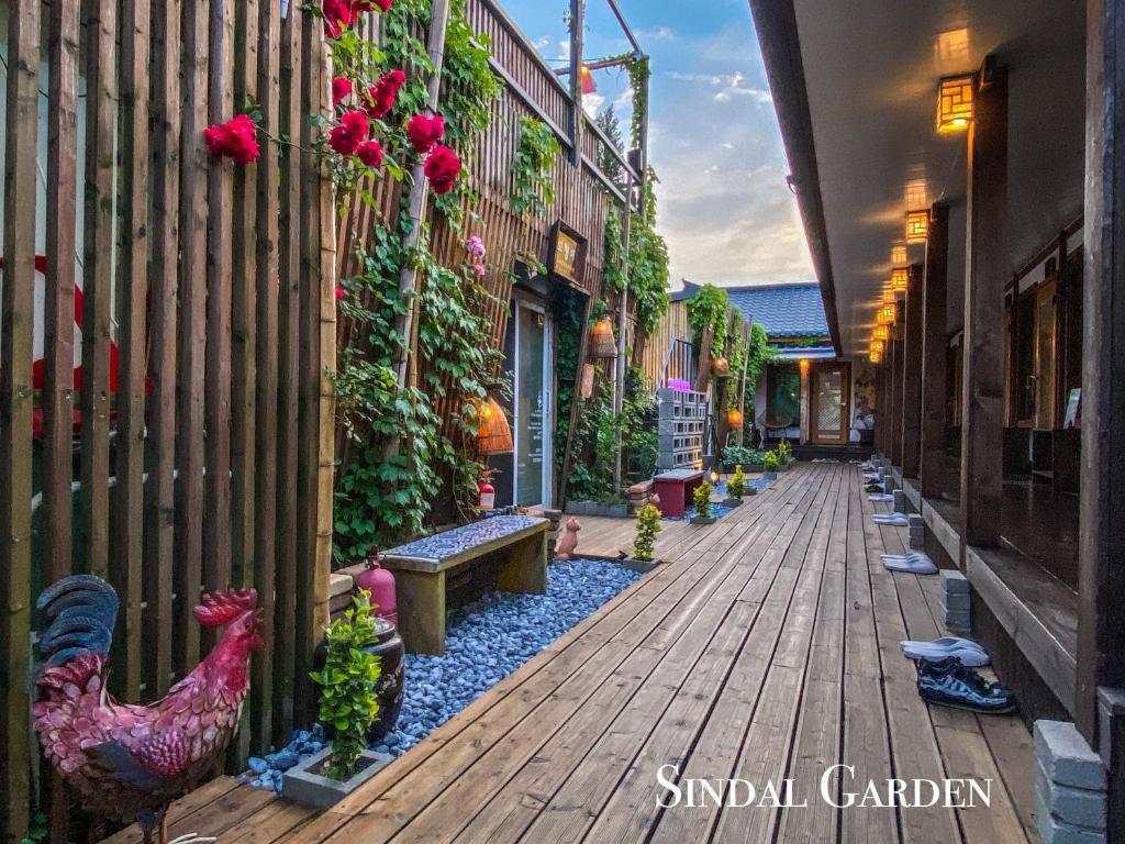 a street with chickens on the side of a building at Architect's Cat Hanok - Sindal House Gyeongju in Gyeongju