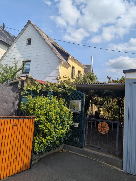 a house with a gate and bushes in front of it at Eva's Home in Müllenbach