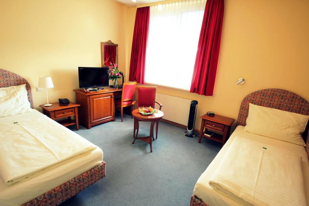 Posteľ alebo postele v izbe v ubytovaní Carinthia Stadthotel