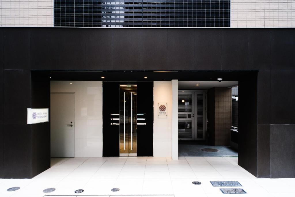 a group of elevators in a black building at Hotel Axas Nihonbashi in Tokyo