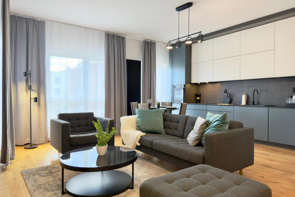 a living room with a couch and a table at Apartament Stara Fabryka 15 in Włocławek