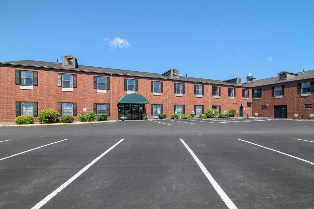 an empty parking lot in front of a large brick building at Quality Inn at Bangor Mall in Bangor