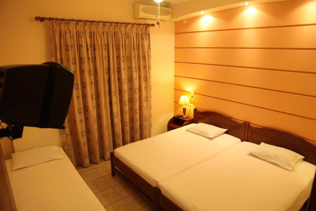 Postel nebo postele na pokoji v ubytování Vasiliki Apartments