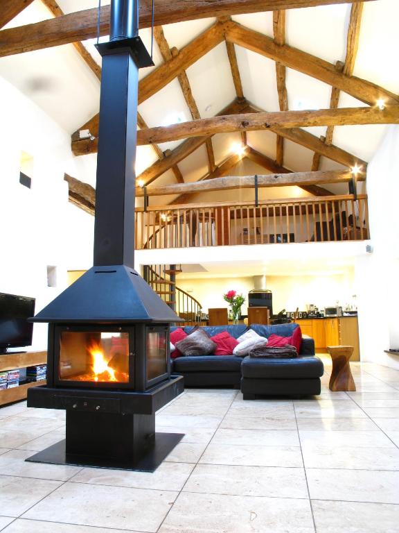 a fireplace in a living room with a couch at The Lazy Fish in Cockermouth