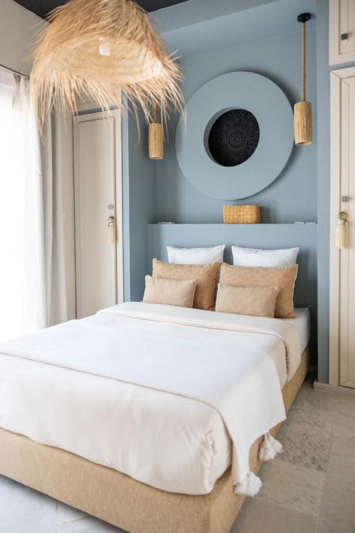 a bedroom with two beds with blue walls at Smala Beldi Guest House in Essaouira
