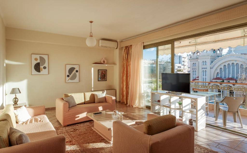 a living room with a couch and a tv at 3BD Apartment in the Center - Self check in in Patra