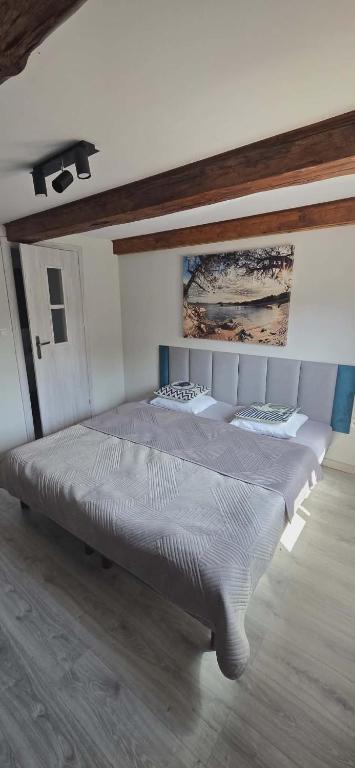 a large bed in a room with at Pokoje Gościnne w Spichlerzu in Ustka