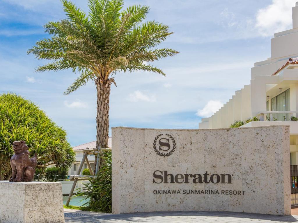 a sign for the sheraton omaha swimming resort with a palm tree at Sheraton Okinawa Sunmarina Resort in Onna