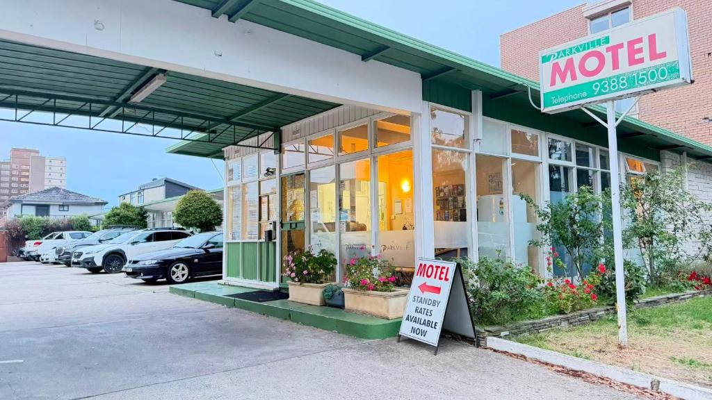 a motel with a sign in front of a store at Parkville Motel in Melbourne