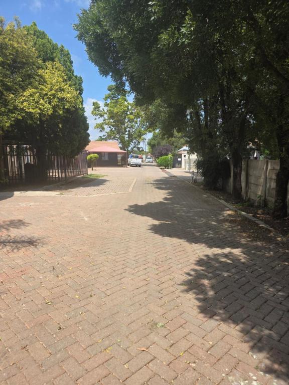a brick road with trees on the sides of it at House 55D in Lichtenburg