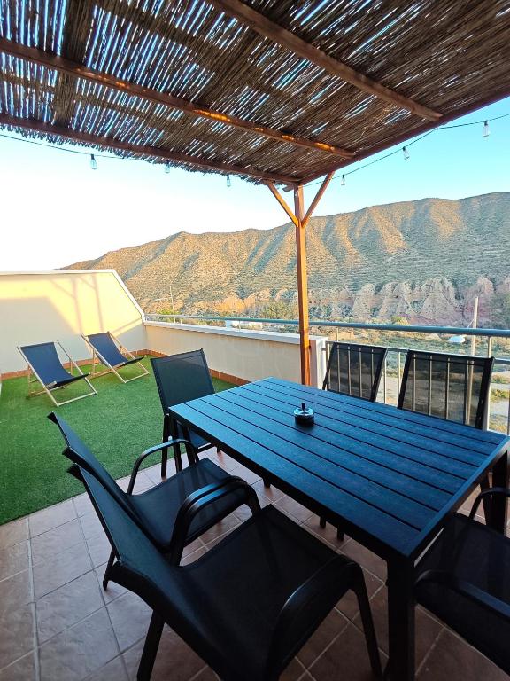 a blue table and chairs on a patio with a view at The New House in Tabernas
