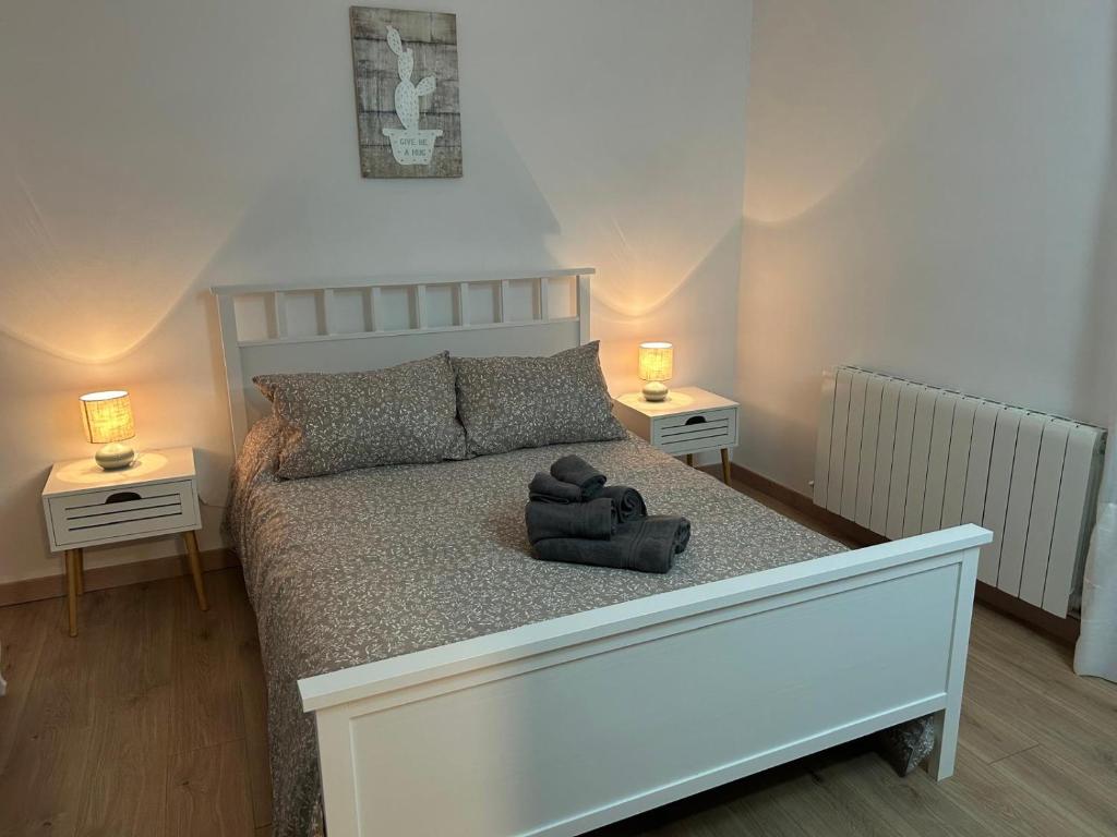 a bedroom with a bed with a teddy bear on it at Casa Marisol in Arrabal de Portillo