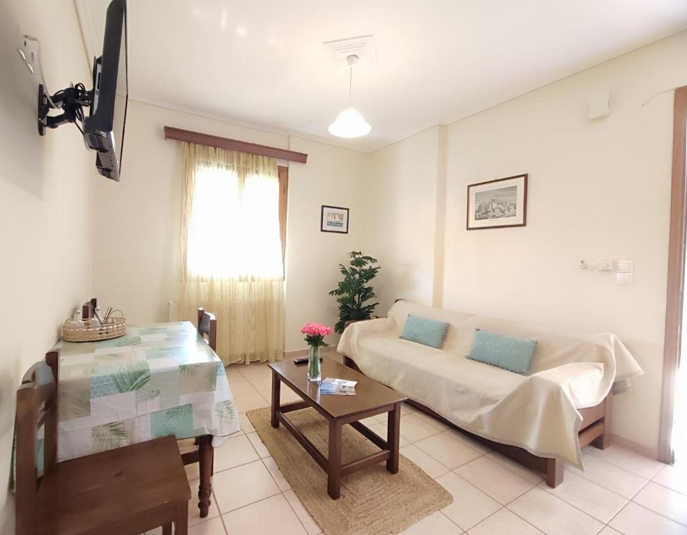 a living room with a couch and a table at Myrstia Apartments in Pyrgi Thermis