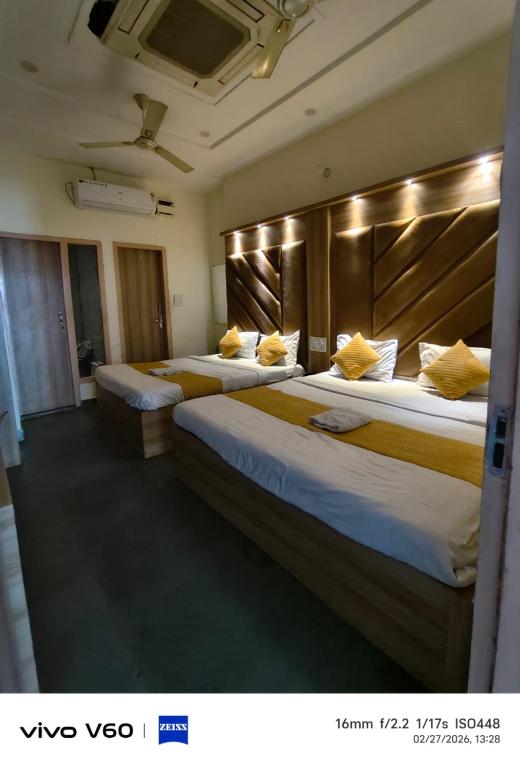 two beds in a hotel room with two bedsvisor at HR King HOTEL in Amritsar