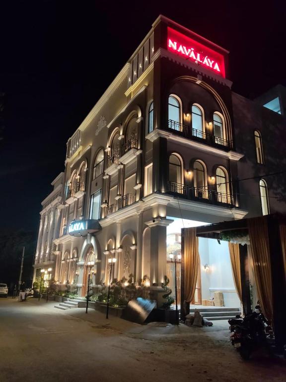 a large building with a sign on it at night at Navalaya in Ludhiana