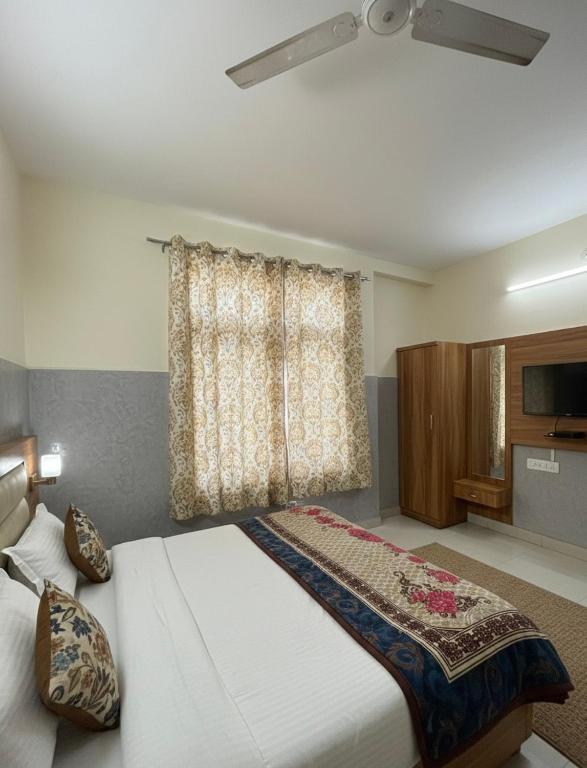 a bedroom with two beds and a window at Mahajan Lodge in Katra