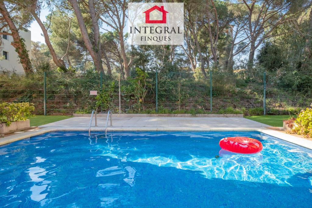 a swimming pool with a red frisbee in it at El Secret de la Fosca in Palamós